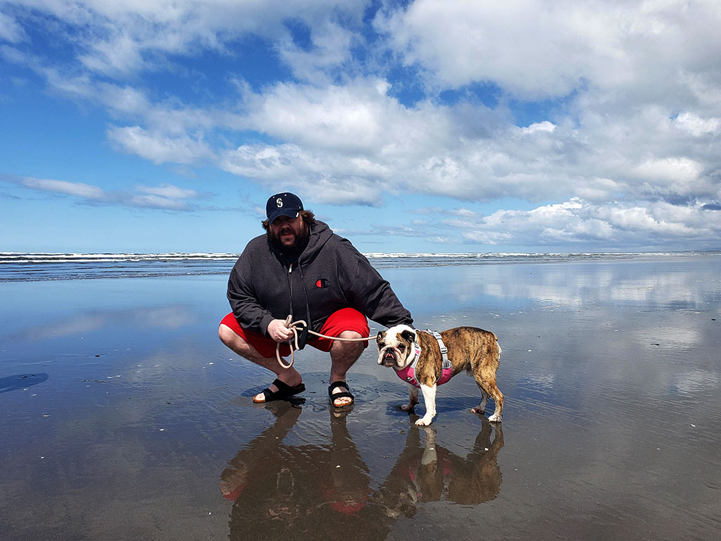 A photo of me and my bulldog Feynman on Pacific Coast in Seaside, OR.